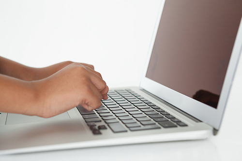 Close-up of schoolboy using laptop