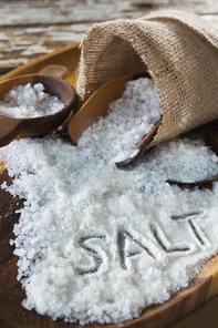 Close-up of salt on wooden plate