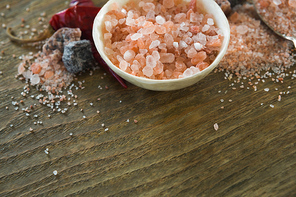 Close-up of himalayan salt with spices on wooden table