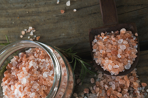 Close-up of himalayan salt and rosemary on wooden table