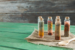 Close-up of various spices in bottles on wooden table