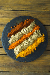 Close-up of various type of spice powder on slate plate