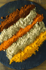 Close-up of various type of spice powder on slate plate