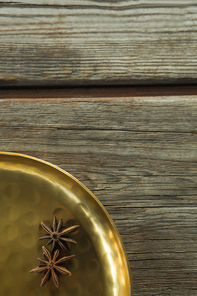 Close-up of star anise in golden plate