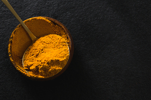 Close-up of turmeric powder in bowl