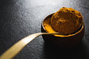 Close-up of turmeric powder in bowl