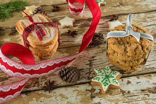 Close-up of cookies and christmas decoration on wooden plank