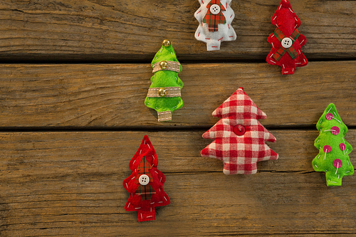 Overhead view of various Christmas tree decoration on wooden table