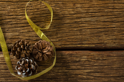 Close up of pine cones with ribbon on wooden table