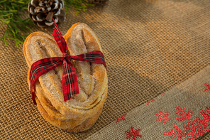 Close up of baked food tied with ribbon on burlap
