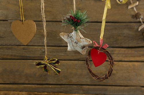 High angle view of Christmas decorations with thread against wooden table