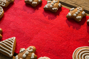 Close up of gingerbread cookies arranged on red fabric at table