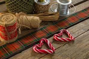 Thread spools with candy cane on table