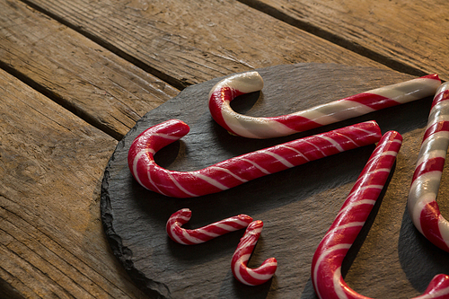 High angle view of candy canes arranged on wood