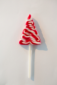 Close-up of christmas tree lollipop on white background