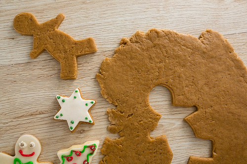 Close-up of gingerbread dough with star shapes on wooden table