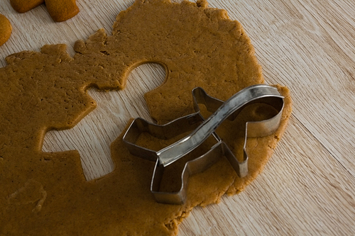 Close-up of gingerbread dough with cookie cutter on wooden table