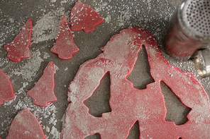 Close-up of cookie dough and flour shaker strainer on table