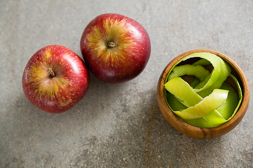 Close-up of peeled green apple and two red apple