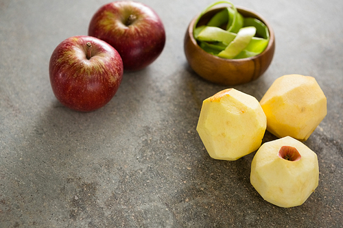 Close-up of peeled green apple and two red apple