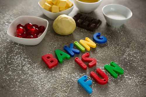 Various baking ingredients and alphabet forming baking is fun on table