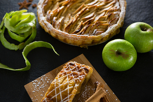 Close-up of tart and apple on concrete background