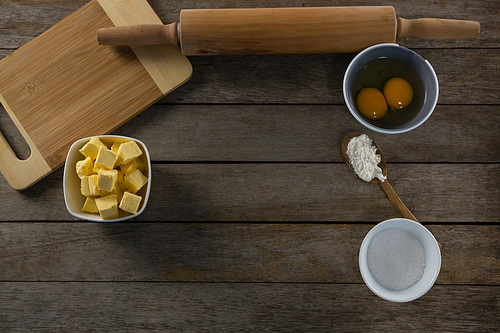 Overhead view of cheese cubes and egg yolk on a wooden table