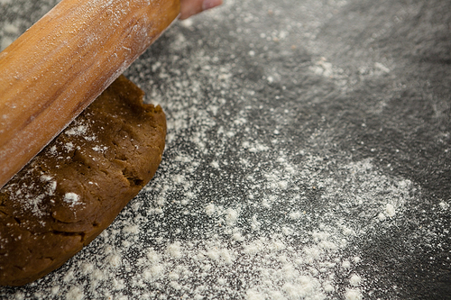 Close-up of dough with rolling pin