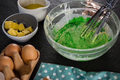 Close-up of green color batter whisked in a bowl