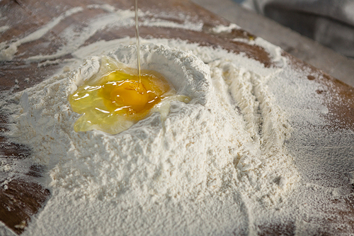 Close-up of liquid egg poured on flour