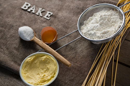 Close-up of flour inside sieve placed over wheat stem