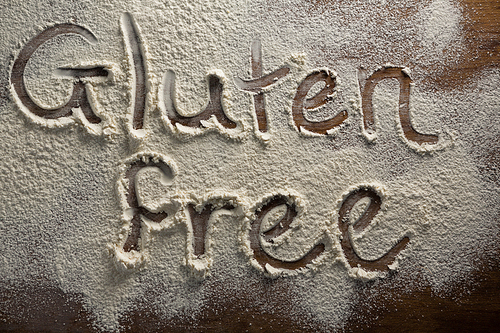 Over head view of the word gluten free written on sprinkled flour