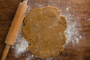 Over head view of flattened dough on a wooden table