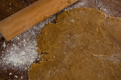 Close-up of flattened dough on a wooden table