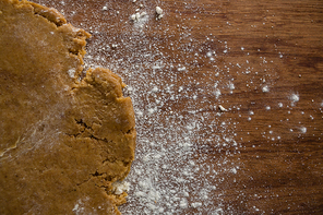 Close-up of flattened dough on a wooden table