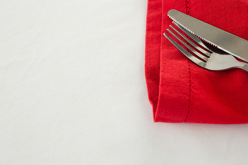 Close-up of fork and butter knife with napkin