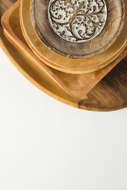 Close-up of wooden plates set on dinning table