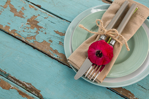 Overhead of table setting on weathered wooden plank