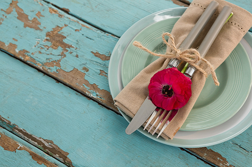 Overhead of table setting on weathered wooden plank