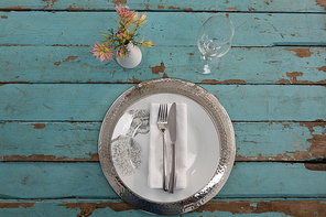 Overhead of table setting on weathered wooden plank