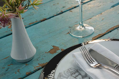 Close-up of table setting on weathered wooden plank
