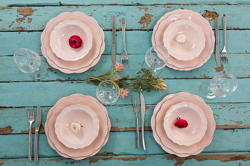 Overhead of elegance table setting on weathered wooden plank