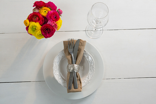 Overhead of elegance table setting on wooden plank