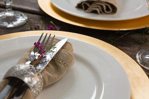 Close-up of elegance table setting on wooden plank