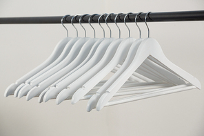 Close-up of hangers arranged on clothes rack
