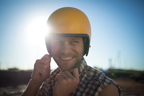Portrait of man wearing a helmet on a sunny day
