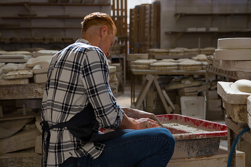 Male potter making a pot