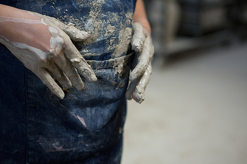 Mid section of girl with muddy hands