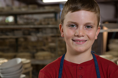 Portrait of smiling boy in pottery workshop