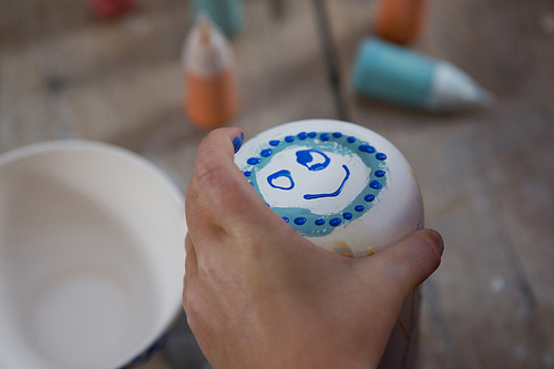 Close-up of smiley face on mug
